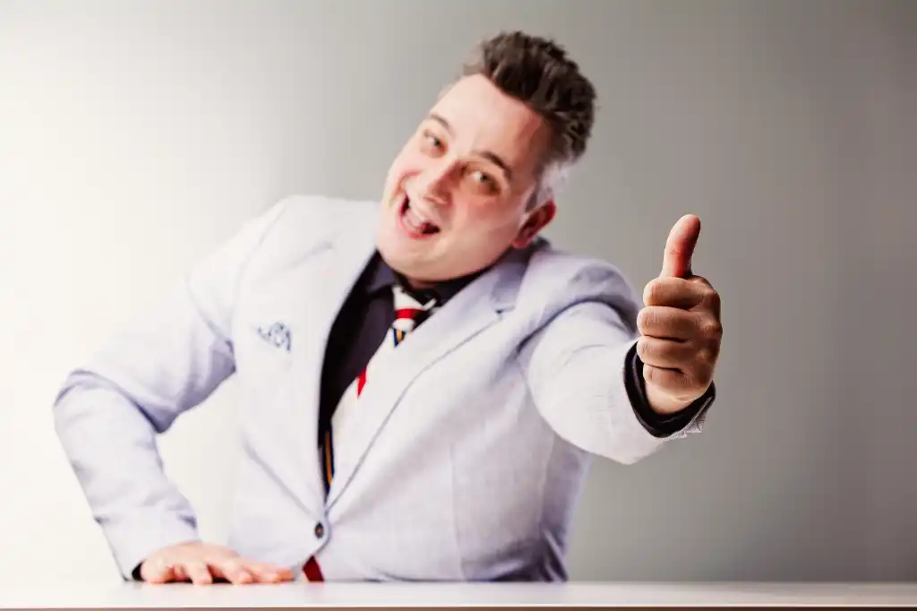 Salesman laughs deceptively with a thumbs up, warning of shady business practices