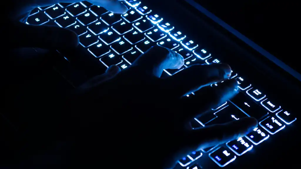 hacker doing bad things on laptop