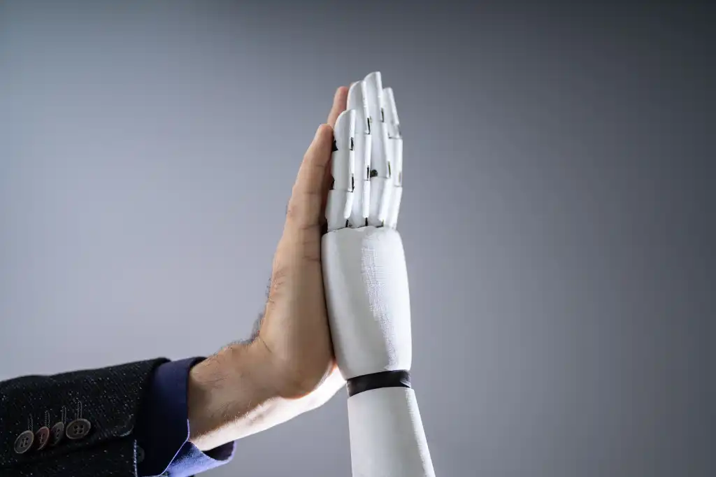 shutterstock 1612680487 Close-up Of Robot And Man Giving High Five Against Digital Background