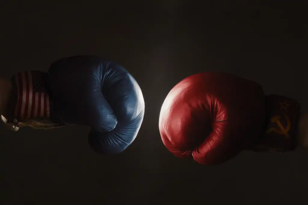 blue and red boxing gloves face off against a black background
