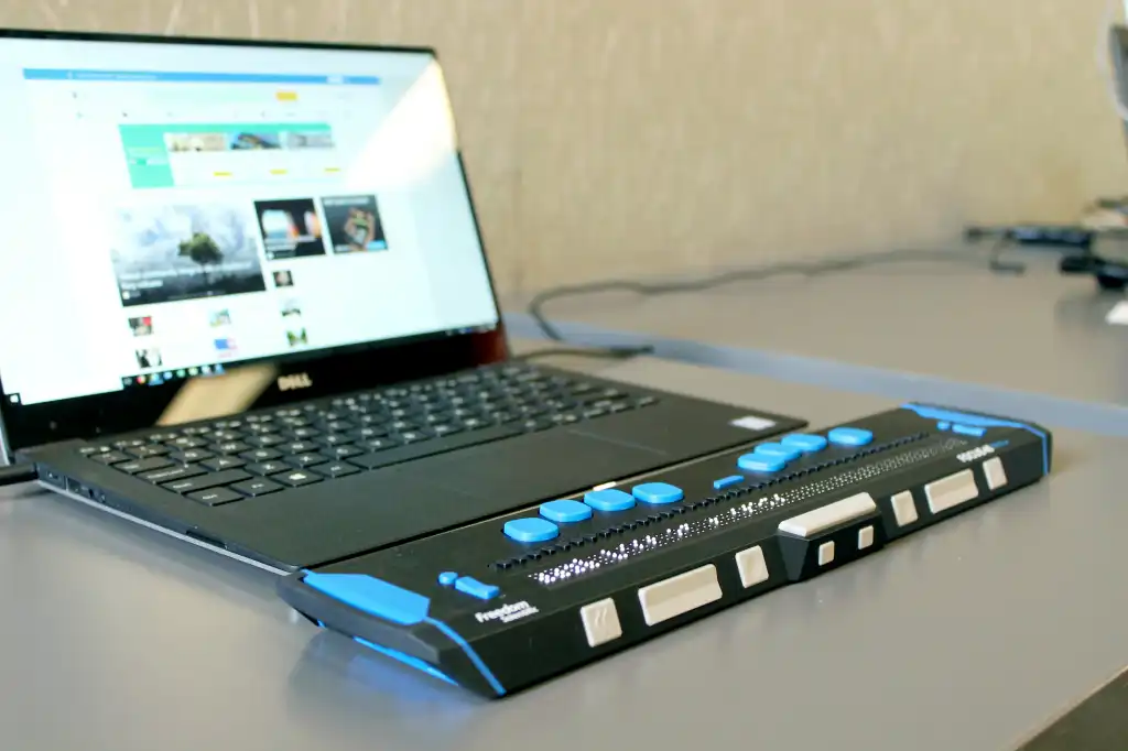 A laptop computer with a refreshable braille display for accessibility.